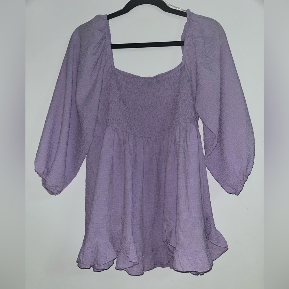 Bought from a boutique. Only worn once. 3/4 sleeve ruffle bottom, stretch back.